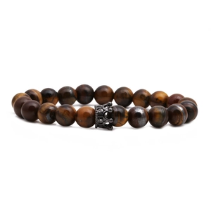 Beaded tiger eye stone bracelet with black crown charm on a clean white background