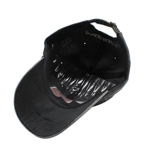 Detail view of cotton baseball cap interior featuring a sewn USA flag on the brim