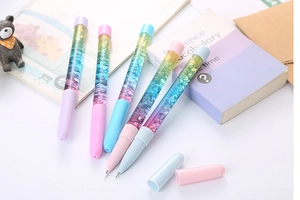 Macro detail of 5 quicksand glitter pens in pastel colors with stars and heart sequins