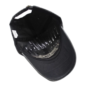 Detailed interior of cotton baseball cap with wash label and vintage metal buckle
