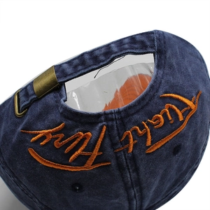 Navy washed cotton baseball cap with orange embroidery and adjustable metal buckle back