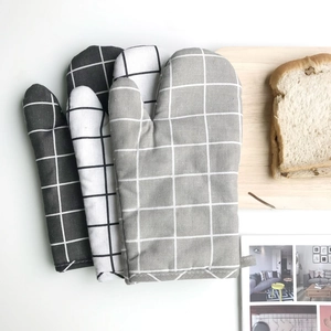 Close-up of Nordic style cotton linen oven mitts with plaid pattern and hanging loops