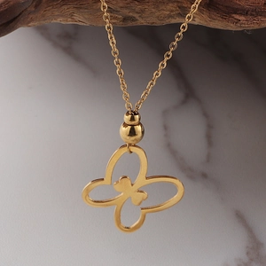 18K gold plated necklace with hollow butterfly pendant hanging on a natural branch