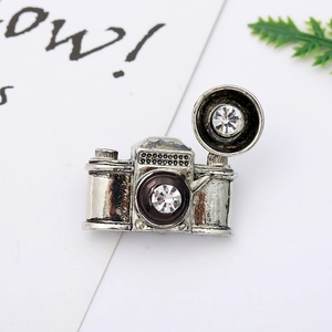 Detail shot of vintage camera brooch with zinc alloy silver finish and clear rhinestones