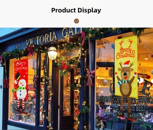 Close-up of hanging Merry Christmas banners with snowman and reindeer in festive street setting