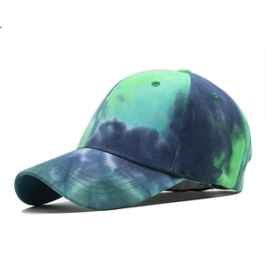 Close-up of tie-dye baseball cap featuring blue and green gradient patterns and eyelets