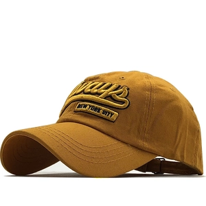Detail of 3D embroidery on yellow cotton baseball cap with adjustable metal buckle
