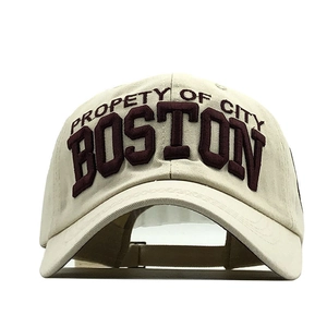 Detail view of cream baseball cap with red Boston 3D embroidery on front