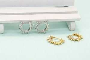 Punk style hoop earrings with spiked studs and micro-set cubic zirconia in gold and silver