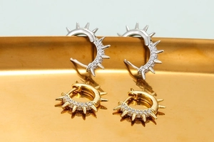 Punk style hoop earrings with spiked studs and pave zircon in gold and silver finish