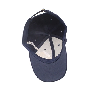 Detail of the navy blue baseball cap interior showing stitching and white front reinforcement