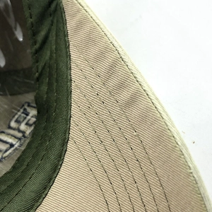 Close-up of khaki and army green baseball cap brim with reinforced multi-row stitching