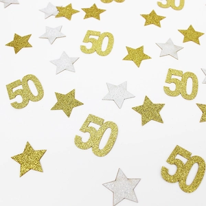 Close-up of shiny gold and silver star and number 50 confetti for 50th birthday party decor