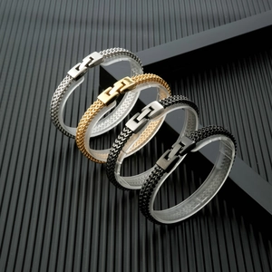 Detail showing four dragon bone chain bracelets in silver, gold, and black finishes