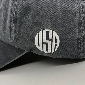 Detail of vintage gray washed cotton baseball cap with embroidered USA logo