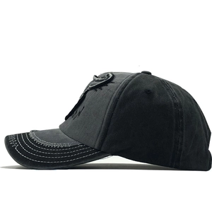 Side view of washed charcoal baseball cap with distressed details and vintage embroidery