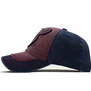 Detail view of vintage washed baseball cap with cow head patch and distressed stitching