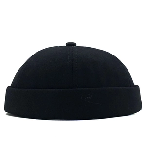 Detail of a black cotton docker cap showing texture and seamless cuff stitching