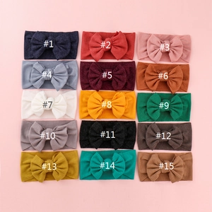 Set of 15 ribbed knit baby headbands with oversized bows in various assorted colors