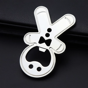 Close-up of a silver bunny head shaped metal bottle opener on a black leather background