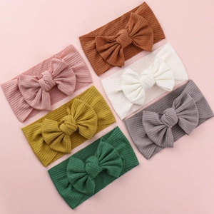 Set of six soft knitted baby headbands with large bows in diverse neutral earth tones