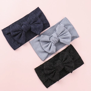 Three-pack of ribbed knit baby headbands with oversized bows in navy, gray, and black colors