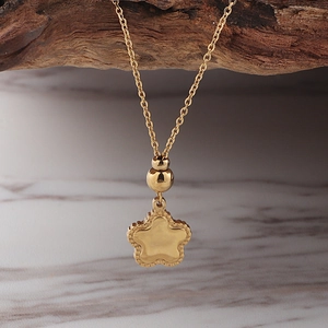 Minimalist stainless steel gold starfish necklace with beads on dark wood background