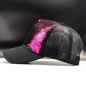 Detail of black mesh baseball cap with reversible pink and purple sequins on front