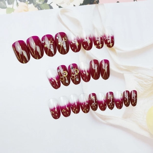 Star and moon wine red gradient press-on nails with gold leaf and rhinestone accents