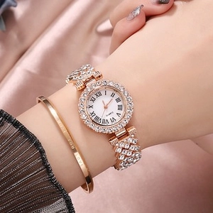 Detail of rose gold quartz watch and bracelet set with crystal pavé and Roman numerals
