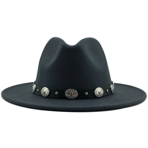 Detail of dark grey fedora hat with metallic rivets and vintage belt on wide brim