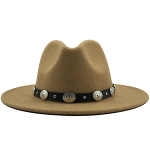 Close-up of camel wool fedora hat with vintage metal buckles and black leather band