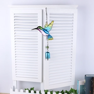 Detail of colorful hummingbird wind chime with blue bell and metallic tubes for garden