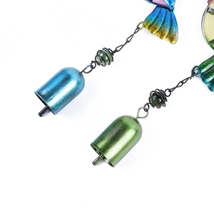 Close-up of vintage gradient blue and green metal bells with antique texture and beads