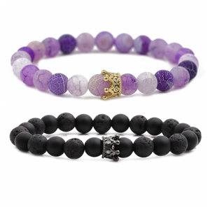 Set of 8mm lava rock and purple agate bead bracelets with crown charms on white background