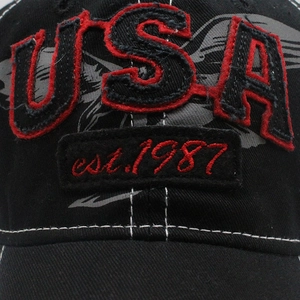 Detailed close-up of the vintage USA embroidery and red stitching on a black denim baseball cap