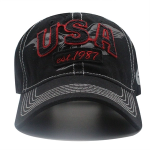 Close-up of 3D embroidered USA and eagle logo on washed black denim baseball cap