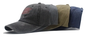 Detail of four washed cotton baseball caps with USA embroidery and flag in multiple colors