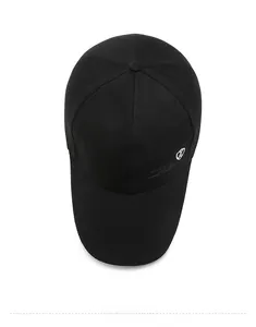 Detail of black cotton baseball cap showing side shield logo and fine stitching texture