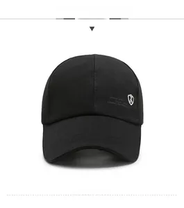 Detail of black cotton baseball cap with shield embroidery and triple-stitched brim