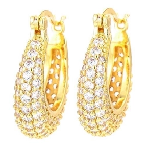 Close-up of golden hoop earrings with pavé zircons and honeycomb lattice design