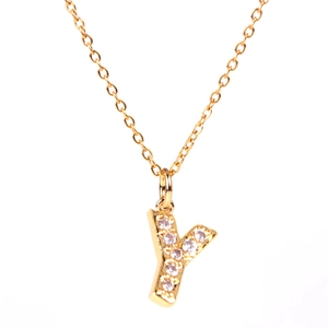Macro detail of gold-plated letter Y pendant necklace with micro-pave zirconia stones