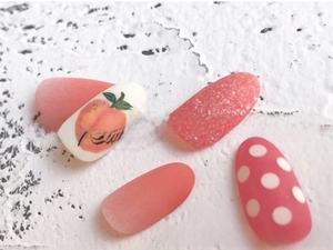 Detail of 3D summer nail stickers featuring peach prints, glitter pink, and matte designs
