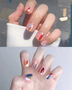 Macro shot of 3D fruit nail art stickers with vibrant multi-color artistic patterns