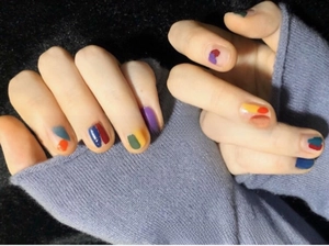 Close-up of abstract 3D colorful fruit nail art decals applied on fingernails