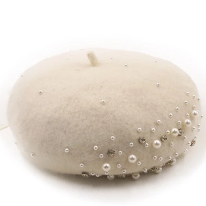 Elegant white wool beret for women decorated with pearls and rhinestones