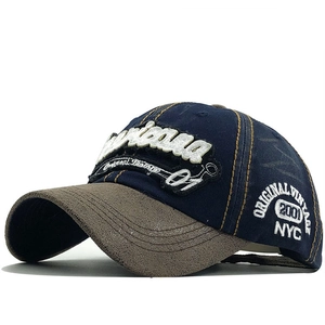 Vintage navy and brown baseball cap with retro embroidery in a 45-degree side view