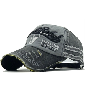 Detailed close-up of distressed washed cotton baseball cap with Rebel 3D embroidery