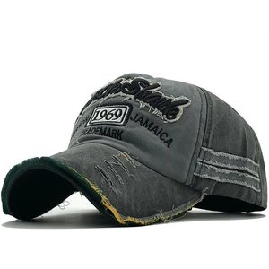 Close-up of distressed brim details and 1969 embroidery on vintage grey baseball cap