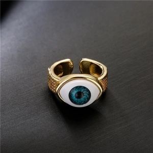 Adjustable 18K gold plated copper evil eye ring with blue resin inlay and textured band